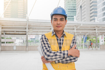 Banner construction engineer man hold blueprint wear blue shirt safety white hard hat at construction site industry plant. Panorama Architecture male civil engineer look at blueprint with copy space.