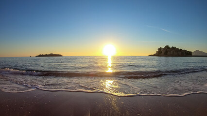 Scenic sunset view from Sveti Stefan Beach at Adriatic Mediterranean Sea, Budva Riviera,...