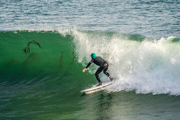 A surfer riding a wave, California