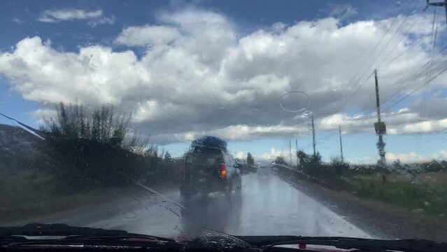 Video of car cabin traveling on road in heavy rain.