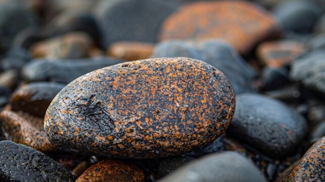 A closeup of a pebble displaying the tiny details and textures that form its unique shape and color..