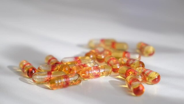 Pile of capsules Omega 3 on white background. Fish and red krill oil soft gel capsules	