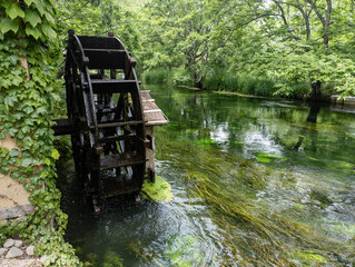 Traditional Japanese waterwheel at a Wasabi farm in Azumino City,  Nagano, Japan