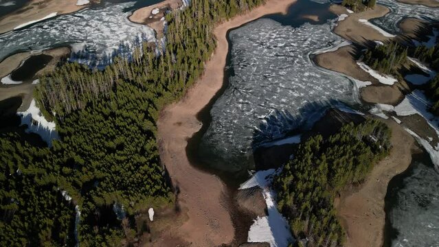 High angle aerial of frozen Lake Dillon in Silverthorne Colorado in spring
