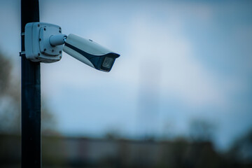 CCTV security camera on blue sky background with copy space for text