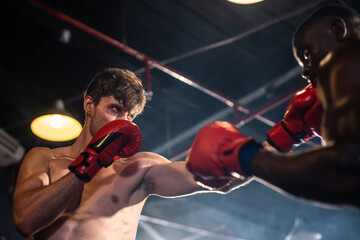 Two young professional boxer having a competition tournament on stage. 