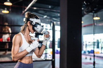 Asian sportswoman using innovative technology VR glasses for exercise. 