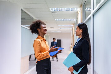 Professional businesswoman talking while stand on corridor in office. 