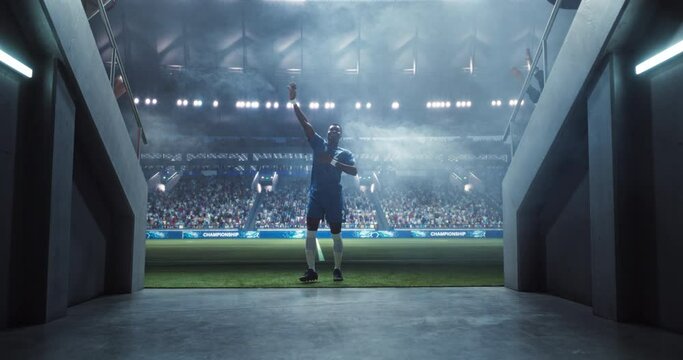 African Soccer Player Walking Through a Dark Tunnel Entrance to a Big Outdoors Stadium Filled with Energetic Sports Fans and Team Supporters. Black Footballer Appreciating Support Before a Match