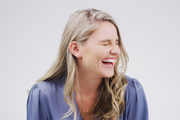 Happy, woman and laughter in studio for funny or comedy for emotions on white background. Smile,...
