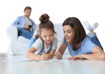 Happy mother smilling daughter lying on warm floor enjoying creative activity, drawing pencils coloring pictures in albums, father resting on couch on a transparent background