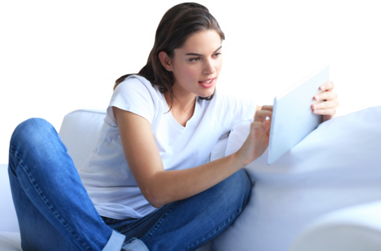 Beautiful young woman using tablet sitting on sofa at home on a transparent background