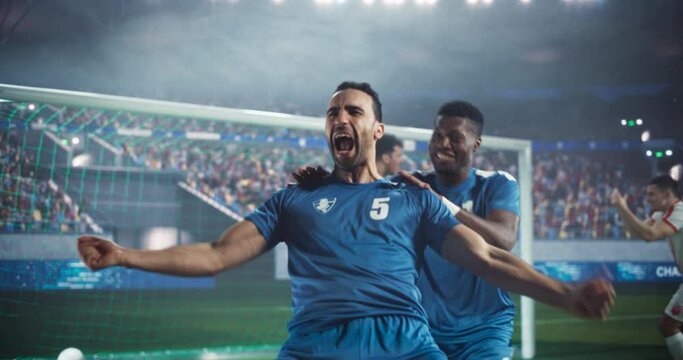 Soccer Championship Game at an Outdoors Stadium: Blue Team Football Forward Player Attacking and Scoring a Goal, Winning the Match. Footballers Celebrating Victory, Winning a Major League Cup