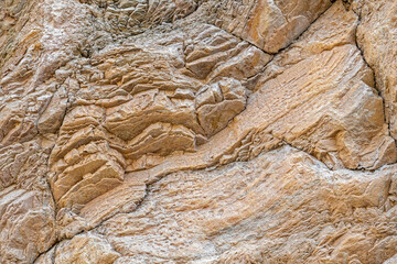 Layered patterns of are erosion evident in the rock walls lining Titus Canyon at Death Valley...