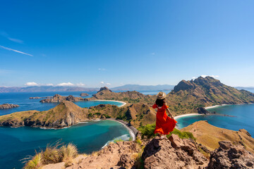Young female tourist enjoying the beautiful landscape at Padar island in Komodo National Park, Indonesia