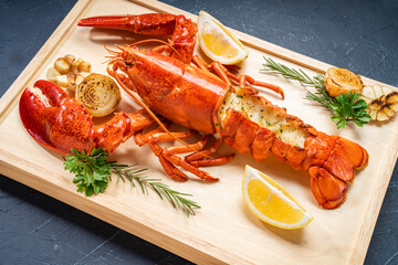 Grilled Lobster with Cheese on wooden plate, Grilled Canadian Lobster on wooden background.