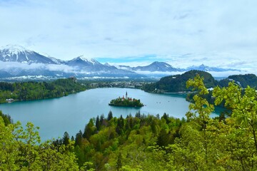View of lake Bled with an island on the lake and mountains in the background in Gorenjska, Slovenia