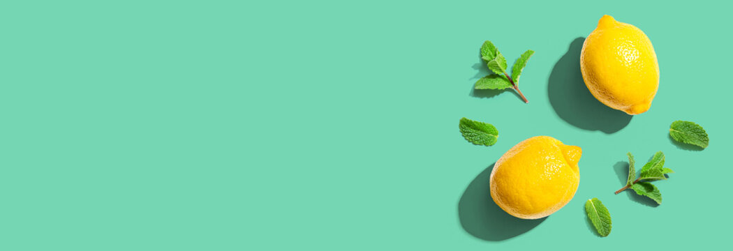 Fresh yellow lemons with mints overhead view - flat lay
