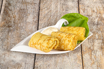 Stuffed pancakes with cream sauce