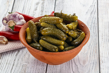Marinated small cucumbers in the bowl