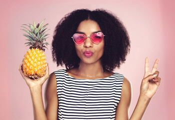 Portrait, woman and pineapple with peace, studio and detox food on pink background. Nutrition,...