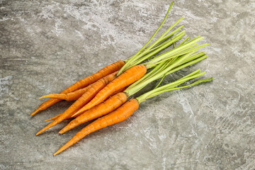 Young raw carrot heap isolated