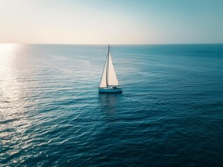Fototapeta premium A serene depiction of a sailboat cutting through the expansive, blue ocean, embodying the sense of freedom and adventure associated with sea voyages.Keywords
