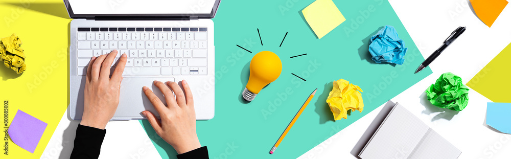 Poster laptop computer with a light bulb from above