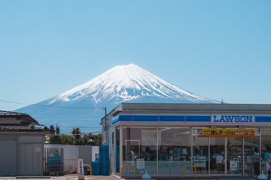 Yamanashi, Japan - April 10, 2023 - Lawson Kawaguchiko Station with Mount Fuji in the background.