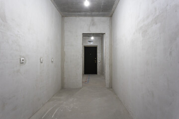 interior of the apartment without decoration in gray colors. rough finish