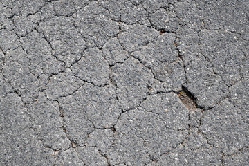 asphalt road with crack texture, top view of damage tarmac driveway surface