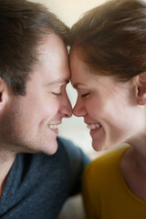 Face, home and couple with love, smile and bonding together with happiness, relationship and care. Apartment, man and woman with marriage, connect and date with romance, affection or relax with smile