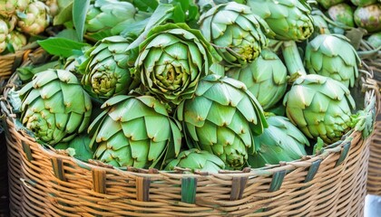 Fototapeta premium A close-up of vibrant green artichokes piled in a woven basket, fresh from the farmers