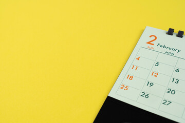 close up of calendar on the yellow table background, planning for business meeting or travel...