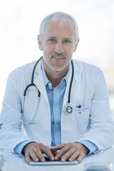 Doctor, mature and portrait with tablet for hospital consulting with stethoscope, cardiology or research. Male person, face and desk for future telehealth or online connection, life insurance or app