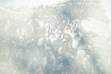 Frosty patterns and tree shadow on window. Rime ice snow on window full frame, texture background.