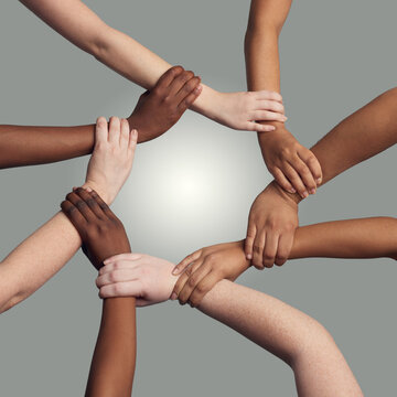 Hands, wrist and together with circle in studio for synergy or collaboration with respect and diversity with harmony. Team, holding and connection in solidarity or alliance, trust and grey background