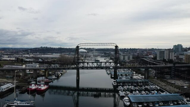 Murray Morgan Bridge Across Thea Foss Waterway In Tacoma, Washington. Tacoma Dome In Distant Background. drone shot