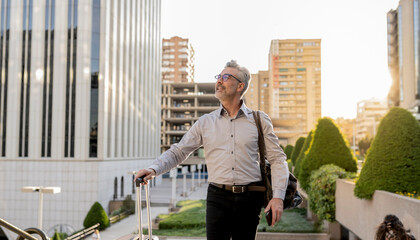 Elderly Businessman With Luggage Exploring Urban Landscape