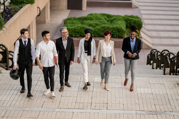 Fototapeta premium Dynamic Corporate Team Walking Together in Business District
