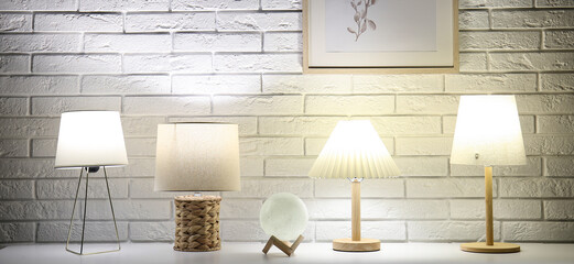 Different glowing lamps on table in dark room