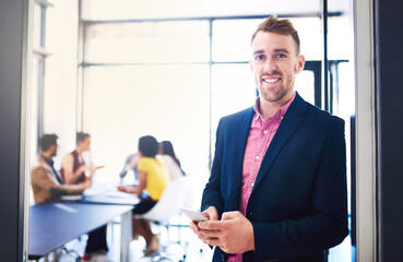 Business man, portrait and smartphone in office with team in background for corporate work and...