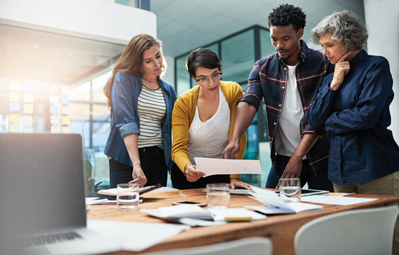 Documents, brainstorming and business people in meeting, creative agency or cooperation for ideas. Review, office and group with paperwork, collaboration for project and partnership with teamwork