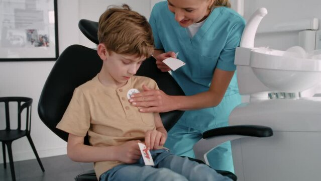 Little boy getting a sticker after the dentist's appointment