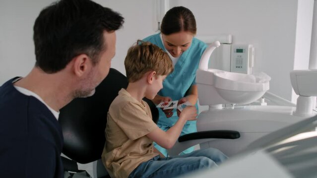 Little boy getting a sticker after the dentist's appointment