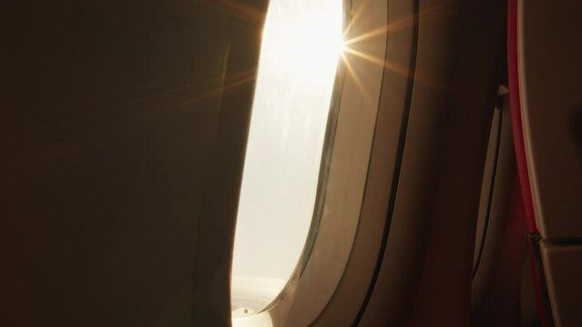 Sun shining through the airplane window during flight