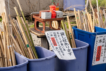 Kotohira, Kagawa, Japan - April 7 2024 : lending cane 100 yen per stick at Konpira Shrine Omotesando street.