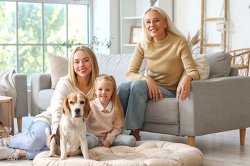 Happy family with cute dog at home