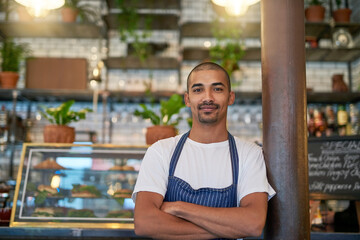 Portrait, business and Brazilian man at cafe with confidence in startup, growth and ownership. Coffee shop, waiter and smile or satisfied with restaurant progress and investment as entrepreneur