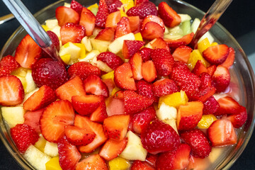 close-up view of a fruit salad covered with strawberries